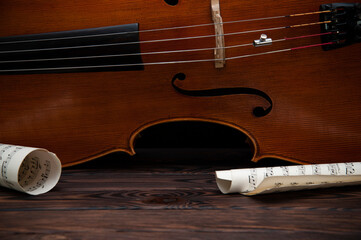 The cello lies on its side on a wooden surface. Place for text