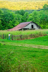 a old barn with a fence around it
