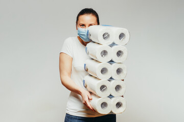 Young woman with bulk of toilet paper packages. - 375625756