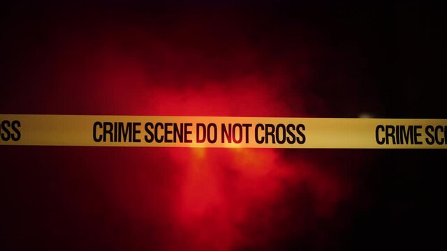 Crime scene police fence against the background of police flashing lights.