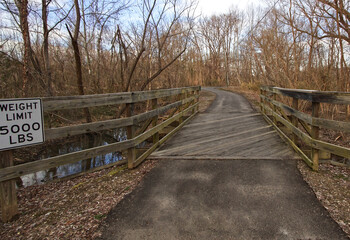 Bridge over the creek and wavy road with a 5000 pound weight limit sign