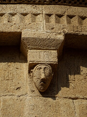 UNESCO World Heritage. Romanesque apse of the Cathedral of Tarragona. (12-13 century) Spain. Detail of the cornice and corbel of a face.    © JOSEANTONIO