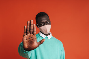 Serious afro american man wearing medical mask