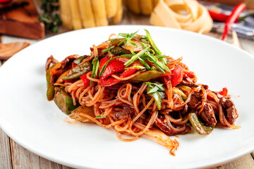 Closeup on asian noodles with beef and vegetables