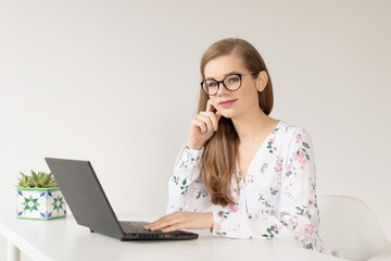 Young woman in glassess studying from home - obrazy, fototapety, plakaty