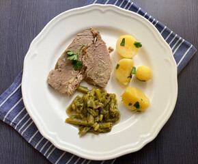 Boiled beef meat with dill cream green beans and boiled potatoes with parsley. Traditional Austrian dish.