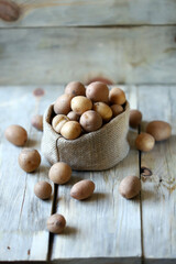 Selective focus. Small raw potatoes in a bag. Baby potatoes. Rustic style. Rustic potatoes.