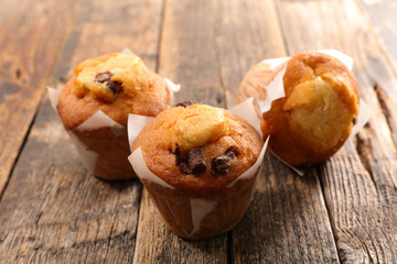 muffin with chocolate chips on wood background