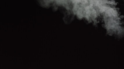 White water vapour on a black background. Close-up shot. White Fume Slowly Floating Rises Up. Abstract Haze Cloud. Animation Mist Effect. Smoke Stream Effect 4K