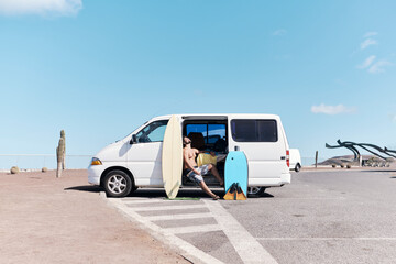 Man With Surfboards And Van
