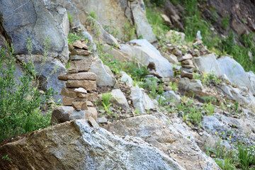 Folded pyramid of different stones in the mountains.
