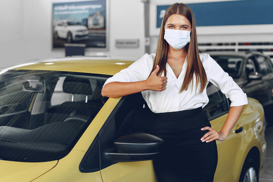 Woman Car Seller Standing Near New Car Wearing Protective Face Mask