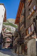 Traditional wooden buildings of Valais canton, Switzerland, at Zermatt (summer, blue sky)