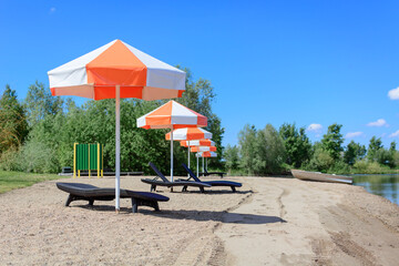 Beach lounger with umbrella for sun protection.