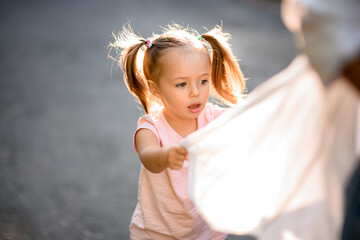 View on little girl with big blue eyes at sunny summer day