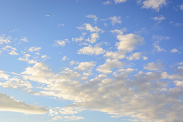 Blue sky with floating white clouds. The background.
