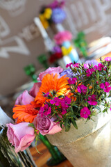 Colorful flowers in a brown vase.