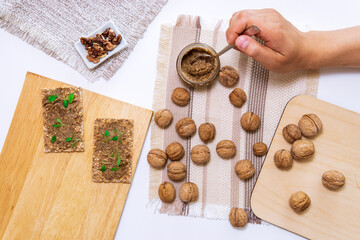 Fototapeta na wymiar raw organic walnut butter or paste, fresh nuts bowl. Top view