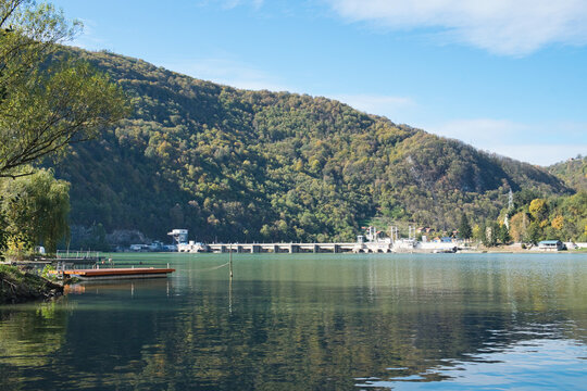 An old fishing boat on the tranquil surface of Drina river on the border between Serbia and Bosnia and Herzegovina