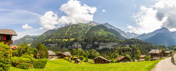Fotobehang Panorama of Champéry, Switzerland, Canton Valais, with typical houses and mountain range Dents du Midi © AventuraSur