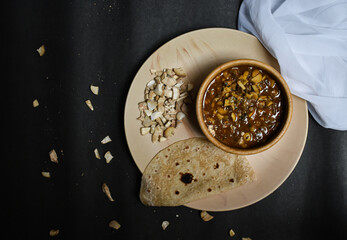 seasonal mushroom vegetable with bread/chapati on a black background