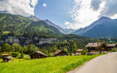 Champéry, Switzerland, Canton Valais, with typical houses and mountain range Dents du Midi