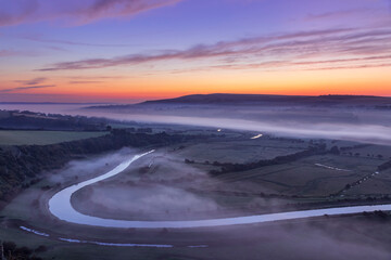 A new day dawns over the Cuckmere valley from High and over south downs east Sussex south east England