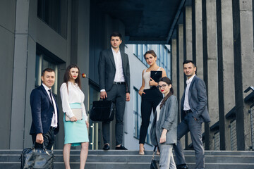 Portrait of successful creative businessman and businesswoman wear formal suits looking at camera and smiling in modern office workplace. Diverse male and female standing together