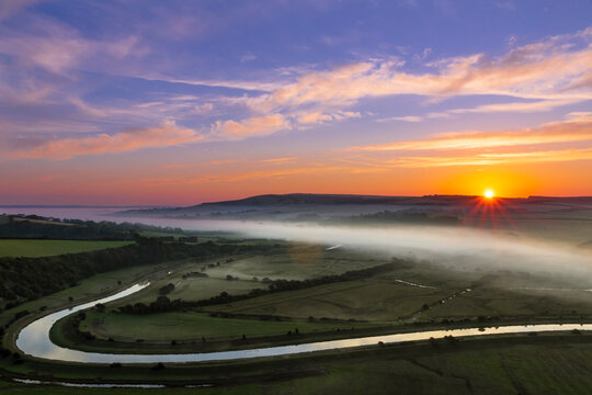 Sunrise over the south downs and morning mist of the cuckmere valley in east sussex south east England