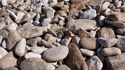 Natural pebbles and stones close-up by the sea, for backgrounds.