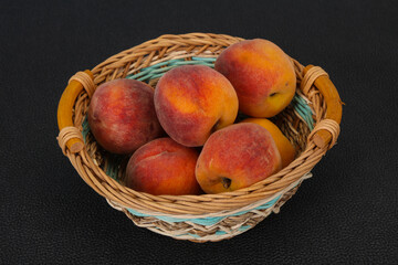 Peach heap in the wooden basket