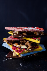 Hand-made bars of colorful chocolate on dark background - 375643717