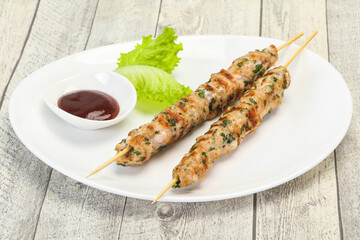 Minced pork skewer kebab with sauce