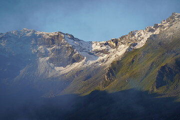 beautiful morning with fog in the valley and sun with clear blue sky in the alps                