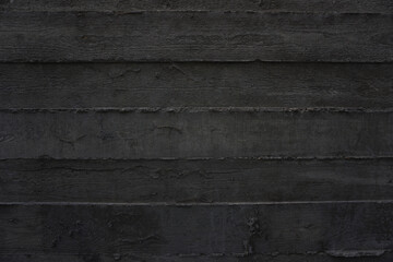 The imprint of wooden planks on gray concrete