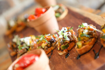 Canapés on a wooden board.