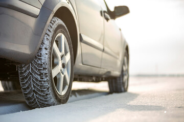 Fototapeta na wymiar Close-up of car wheels rubber tire in deep snow. Transportation and safety concept.