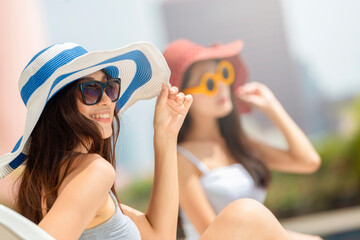 Two Asian woman wearing fashion straw beach hat for skin care sun protection. Face skincare beauty concept. Beautiful adult girl portrait on summer vacation travel.