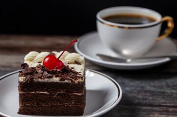 
Chocolate and Black Coffee Cake Placed on the table, wood grain