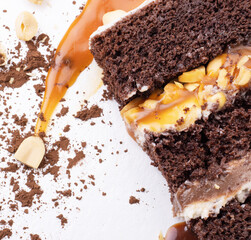 Delicious cream-caramel dessert with peanuts on a white background