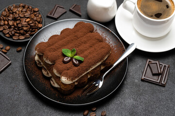 Classic tiramisu dessert, cup of coffee, sugar and milk on concrete background