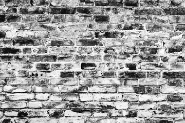 Fototapeta premium Texture of a brick wall with cracks and scratches which can be used as a background