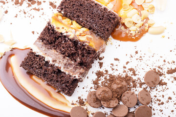 Delicious cream-caramel dessert with peanuts on a white background