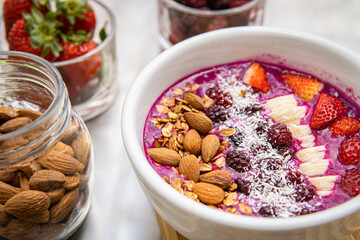Dragon fruit smoothie bowl with berries and toppings, healthy breakfast cereal