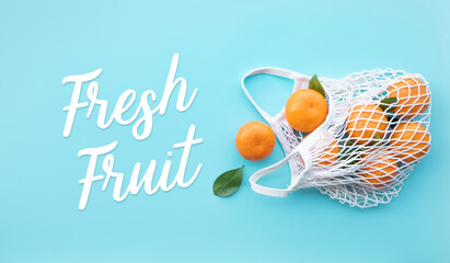 Fresh fruit text with orange from garden in crochet bag