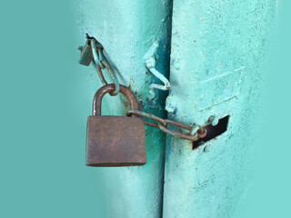 rusty lock with locked blue metal door texture background with space