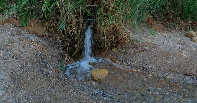 Close up of stream with frash water on the beach