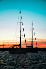 Anchored sailboats silhouette at sunset