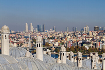 Bosphorus through the chimneys and domes of the ancient ottoman madrasa in Istanbul, Turkey.