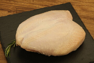 Raw whole chicken breast with skin